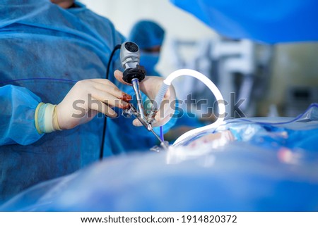 Special tube for operation. Neurosurgery equipment in hands of experienced doctor. Selective focus. Cropped photo. Royalty-Free Stock Photo #1914820372