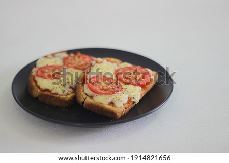 Pizza toast with home baked bread loaf. Shot on white background.