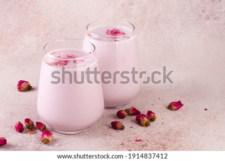 pink moon milk in glass, midnight relaxing drink, roses, pink background Royalty-Free Stock Photo #1914837412