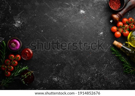 Black stone cooking background. Spices and vegetables. Top view. Free space for your text. Royalty-Free Stock Photo #1914852676