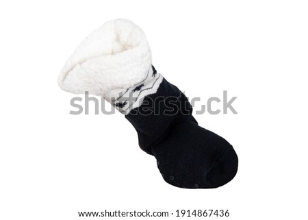 Socks isolated. Closeup of a single black warm thick wool sock with ornaments for the cold winter isolated on a white background.