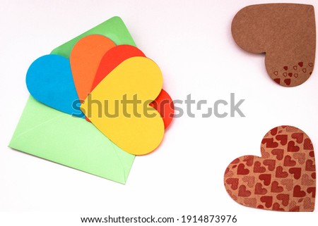 colorful heart-shaped papers for bisexual love messages or for gay chat sites concept photo on colorful envelopes. copy space for your text. 
