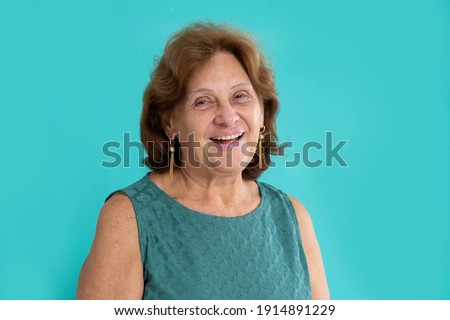 happy senior woman looking and smiling to the camera on colorful Royalty-Free Stock Photo #1914891229