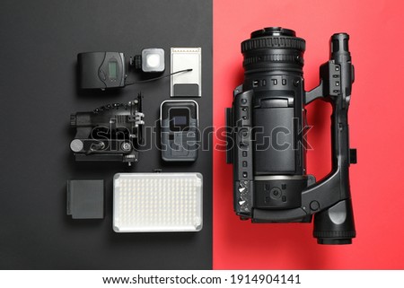 Flat lay composition with camera and video production equipment on color background