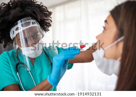 Doctor in Taking a Nasal Swab From a Person to Test for Possible Coronavirus Infection. Experienced lab technician collecting the sample of mucus from the female patient nose for analysis