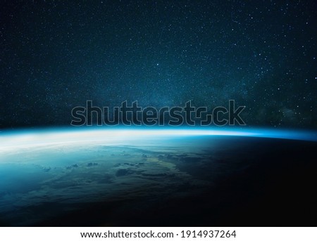 Beautiful blue planet earth with blue glow with starry and milky way. Sunrise in space