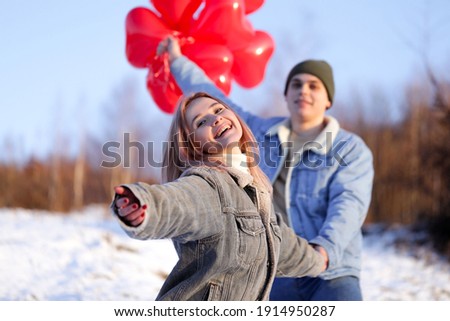 Beautiful cute young couple are together. Pretty funny young couple. Winter love story.Pretty funny young man and woman .Valentines day holiday. 