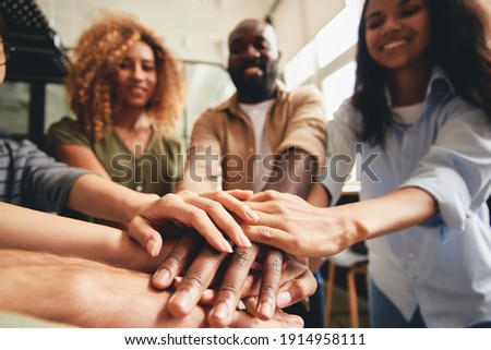 People of different ethnicities uniting to cooperate together Royalty-Free Stock Photo #1914958111