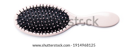 hairbrush isolated on white background. pink hair brush cut out. design element. personal grooming accessory. Royalty-Free Stock Photo #1914968125