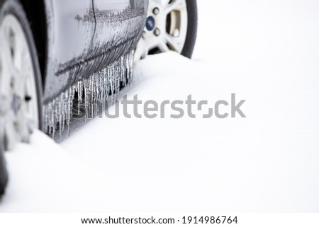 Grey car with snow and ice Royalty-Free Stock Photo #1914986764