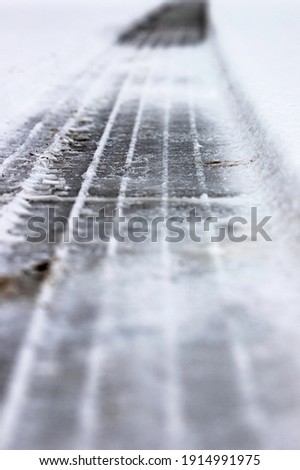 Tire track in the snow Royalty-Free Stock Photo #1914991975