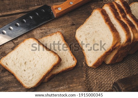 Sliced Bread stock image with wooden background.