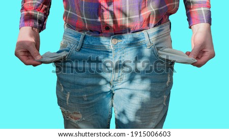 A man with empty pockets, a man without money, a young guy in denim pants has financial problems.