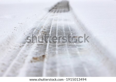 Tire tracks in the snow and ice Royalty-Free Stock Photo #1915013494