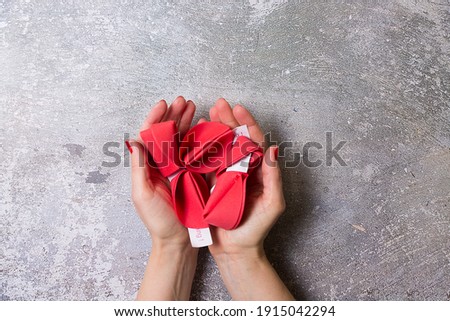 Red Valentine's day fortune cookies on a gray background