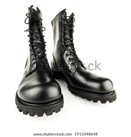 three quarter front view on pair of black leather 10-inch new black military combat boots, isolated on white background