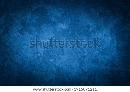 Blue decorative plaster texture with vignette. Abstract grunge background with copy space for design. Royalty-Free Stock Photo #1915071211