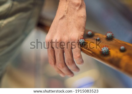 Hand touching footbridge railing handrail, risk to contaminated with germs virus bacteria and pathogen. Covid-19 disease coronavirus outbreak concept Royalty-Free Stock Photo #1915083523