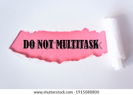 DO NOT MULTITASK message written under torn paper.