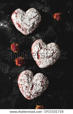 Tasty heart shape form cookies on background table. Homemade red cookie with sugar icing. St.Valentine sweets. Close up view delicious sweet dessert