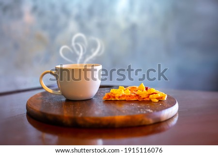 Coffee and small pizza on a wooden plate in a cafe.Photo select focus.