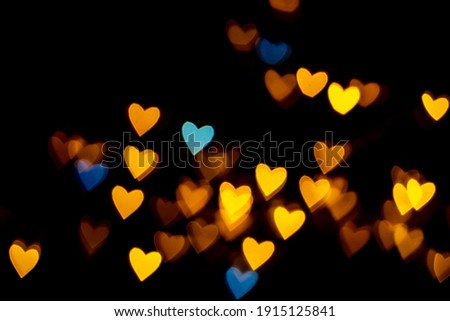 Valentine grunge heart shaped lights background. Yellow gold and blue heart-shaped on black background Colorful lighting bokeh for decoration Valentine, Love Pictures background