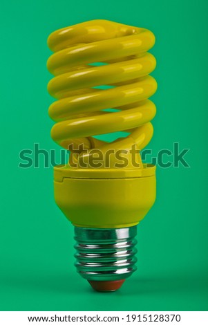 Yellow lamp on green background with copy space close-up. Detail for design. Design elements. Macro. Top view.Minimum idea creative concept. Meditation background for business cards