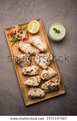 Indian Afghani chicken Malai Tikka is a grilled Murgh creamy kabab served with fresh salad Royalty-Free Stock Photo #1915147687