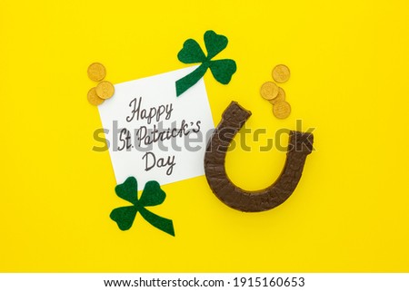 Composition for St. Patrick's Day. Decorating paper with green clover or shamrocks, gold coins and horseshoe