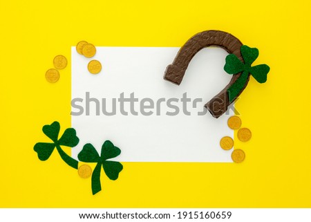 Composition for St. Patrick's Day. Decorating paper with green clover or shamrocks, gold coins and horseshoe