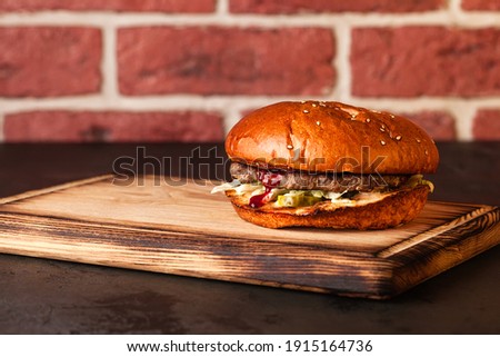 Sandwich. Fast food. Burger with meat and vegetables. Black burger.