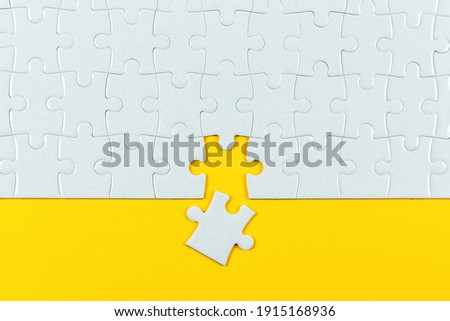 Jigsaw Puzzle on Yellow Background Royalty-Free Stock Photo #1915168936