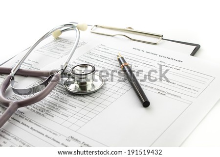 medical history with stethoscope  and pen