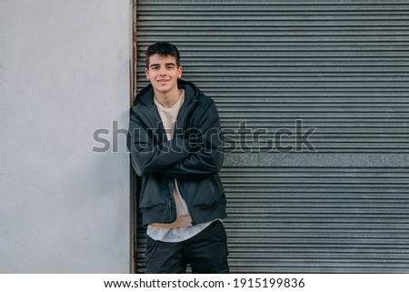 young urban teenager in casual style on the street outdoors