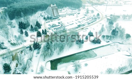 Top view of the winter city with buildings and parks