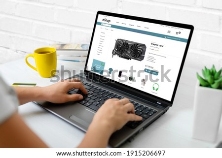 Purchase computer components online concept. Graphic card on modern ecommerce web site on laptop computer Royalty-Free Stock Photo #1915206697