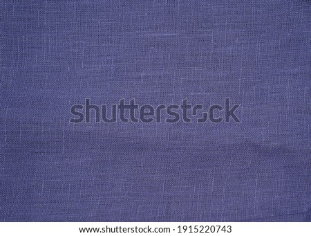 texture of natural blue  or violet fabric or cloth. Fabric texture of natural cotton or linen textile material. Blue background close up in high resolution