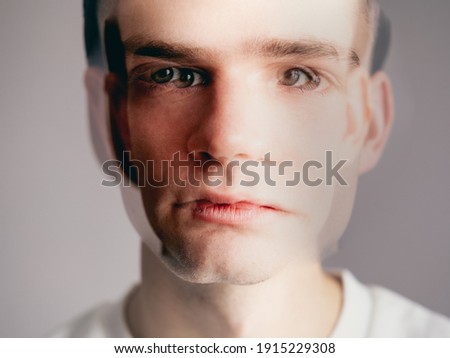 portrait of a young man, a guy out of focus. Multiple personality disorder, bipolar disorder, neurosis, panic attack. Selective focus Royalty-Free Stock Photo #1915229308