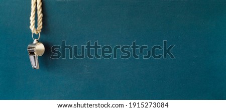 shiny whistle of a soccer referee or trainer, free copy space, panoramic soccer or football mock up Royalty-Free Stock Photo #1915273084