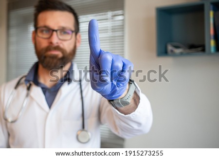 handsome male doctor pressing touch screen