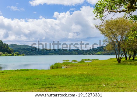 Scenic view of Furnas lake in Sao Miguel island, Azores, Portugal. An enchanting and tranquil scene of lush foliage and the lake in a volcanic crater