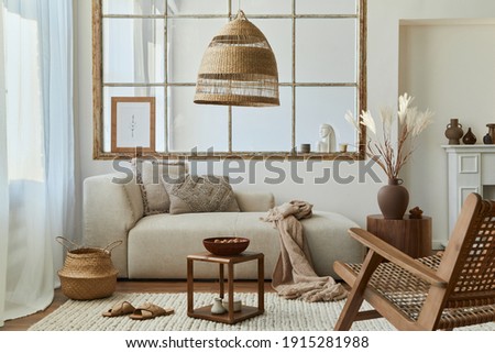 Stylish interior of living room with design modular sofa, furniture, armchair,  coffee table, rattan decoration, mock up picture frame, pillow, dried flowers and accessories in modern home decor.