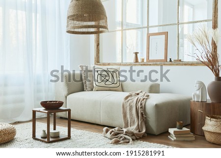 Stylish interior of living room with design modular sofa, furniture, wooden coffee table, rattan decoration, mock up picture frame, pillow, dried flowers and elegant accessories in modern home decor.