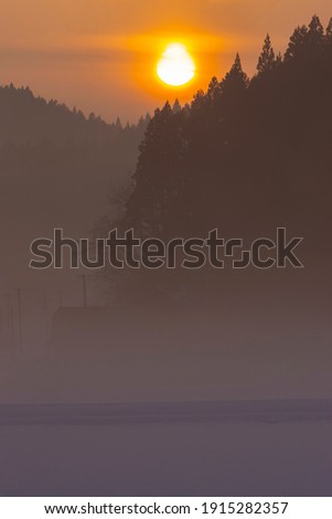 Cold winter sunrise and morning haze