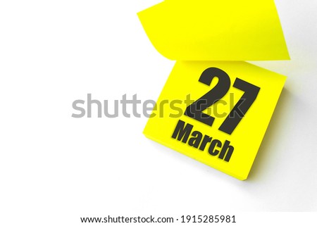 March 27th. Day 27 of month, Calendar date. Close-Up Blank Yellow paper reminder sticky note on White Background. Spring month, day of the year concept