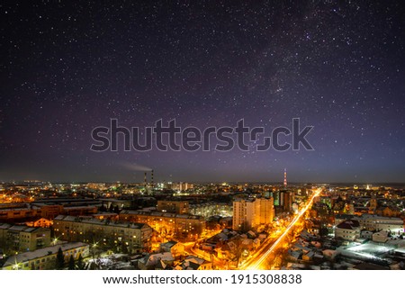 Lights of the night city against the background of the starry sky in Ukraine