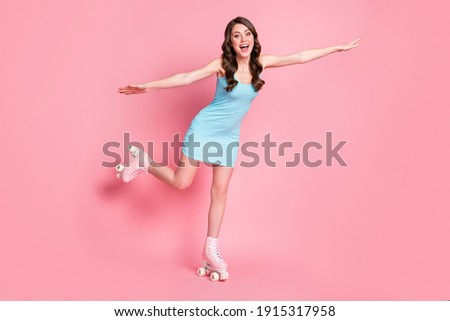 Full size photo of young happy cheerful attractive woman girl female fly hands wings on rollers isolated on pink color background