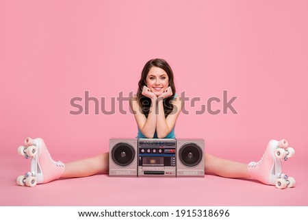 Full size photo of young happy attractive woman girl female sit floor with boombox wear rollers isolated on pink color background