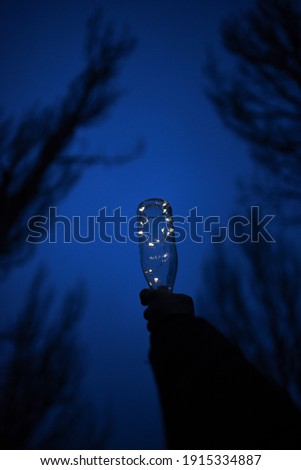 Bottle of lights with background in the sky, magic and illusion concept.