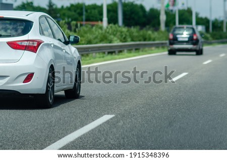 white hatchback on the motorway in sunny day close-up Royalty-Free Stock Photo #1915348396